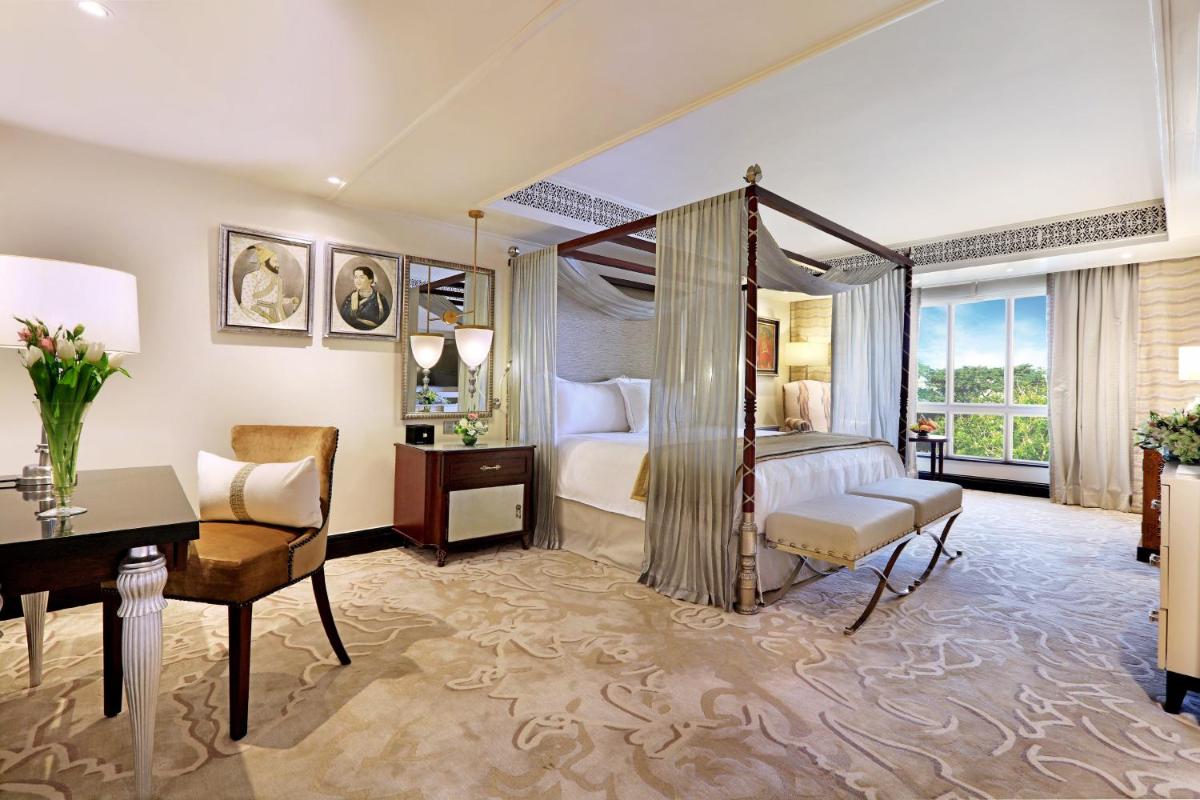 a hotel room with a bed and a desk and a desk at ITC Maratha, a Luxury Collection Hotel, Mumbai in Mumbai