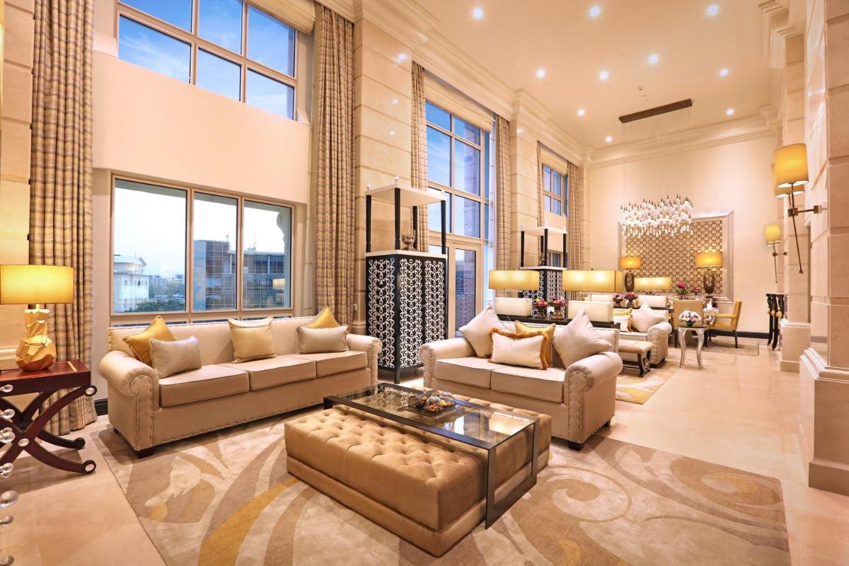 a large living room with couches and a table at ITC Maratha, a Luxury Collection Hotel, Mumbai in Mumbai