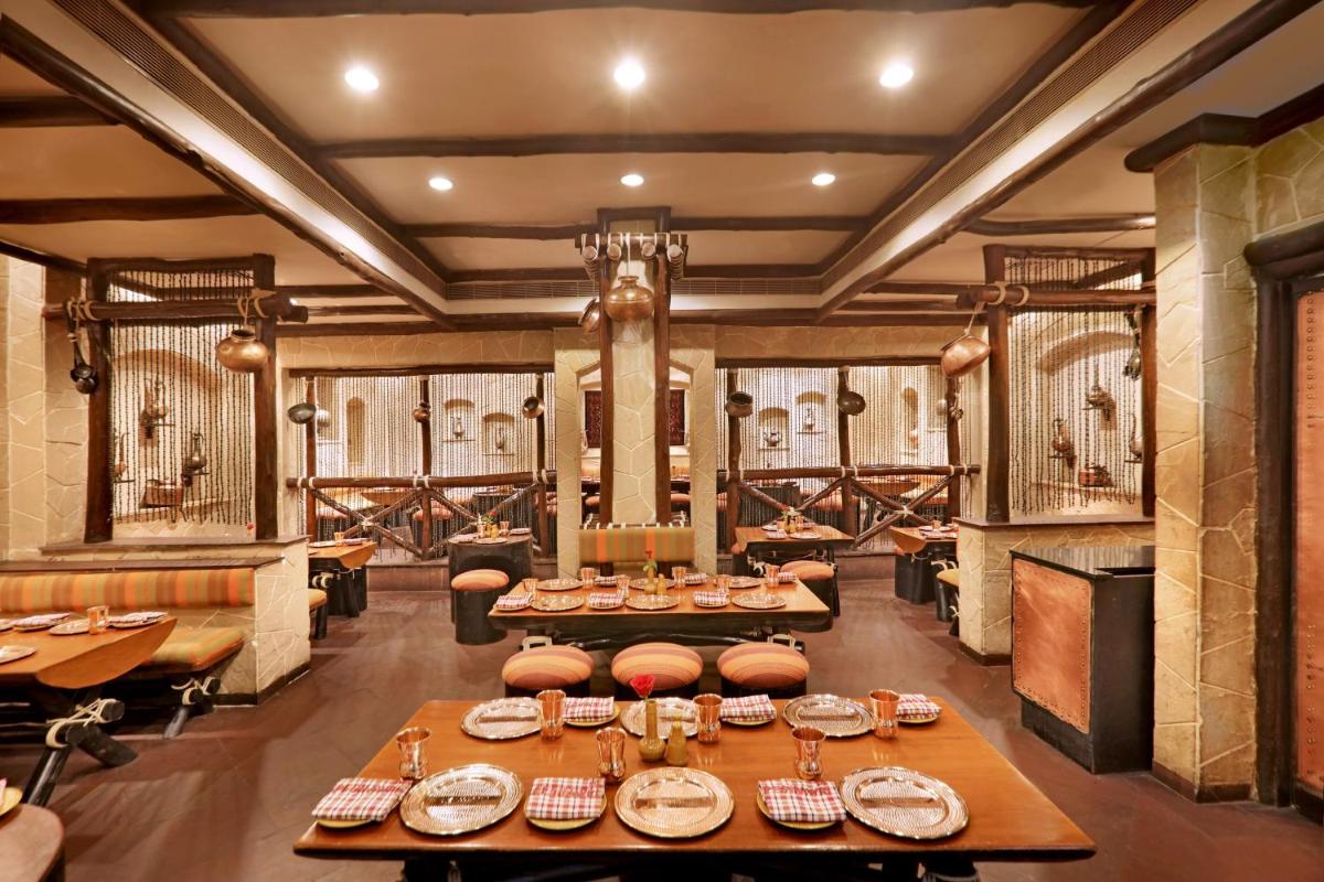 a dining room with a table and chairs and a wine cellar at ITC Maratha, a Luxury Collection Hotel, Mumbai in Mumbai
