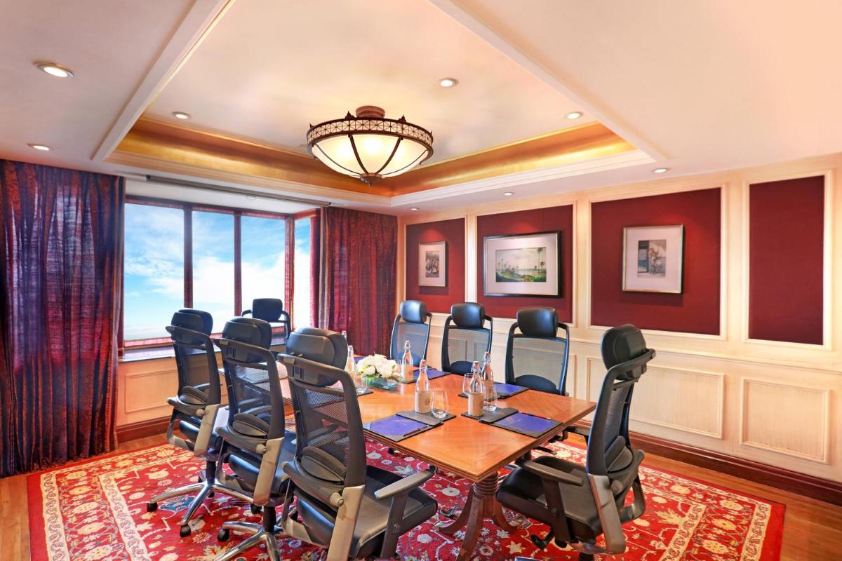 a boardroom with a conference room with a table and chairs at ITC Maratha, a Luxury Collection Hotel, Mumbai in Mumbai