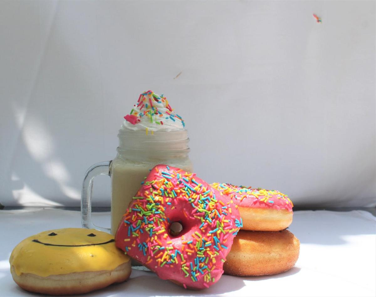 a group of three donuts next to a jar of milk at Crowne Plaza Ahmedabad City Centre by IHG in Ahmedabad