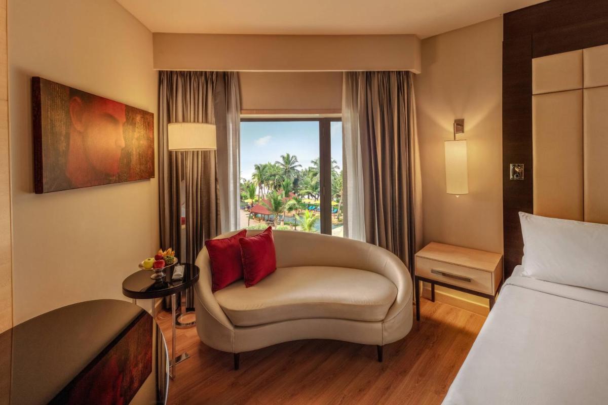a hotel room with a couch and a window at JW Marriott Mumbai Juhu in Mumbai