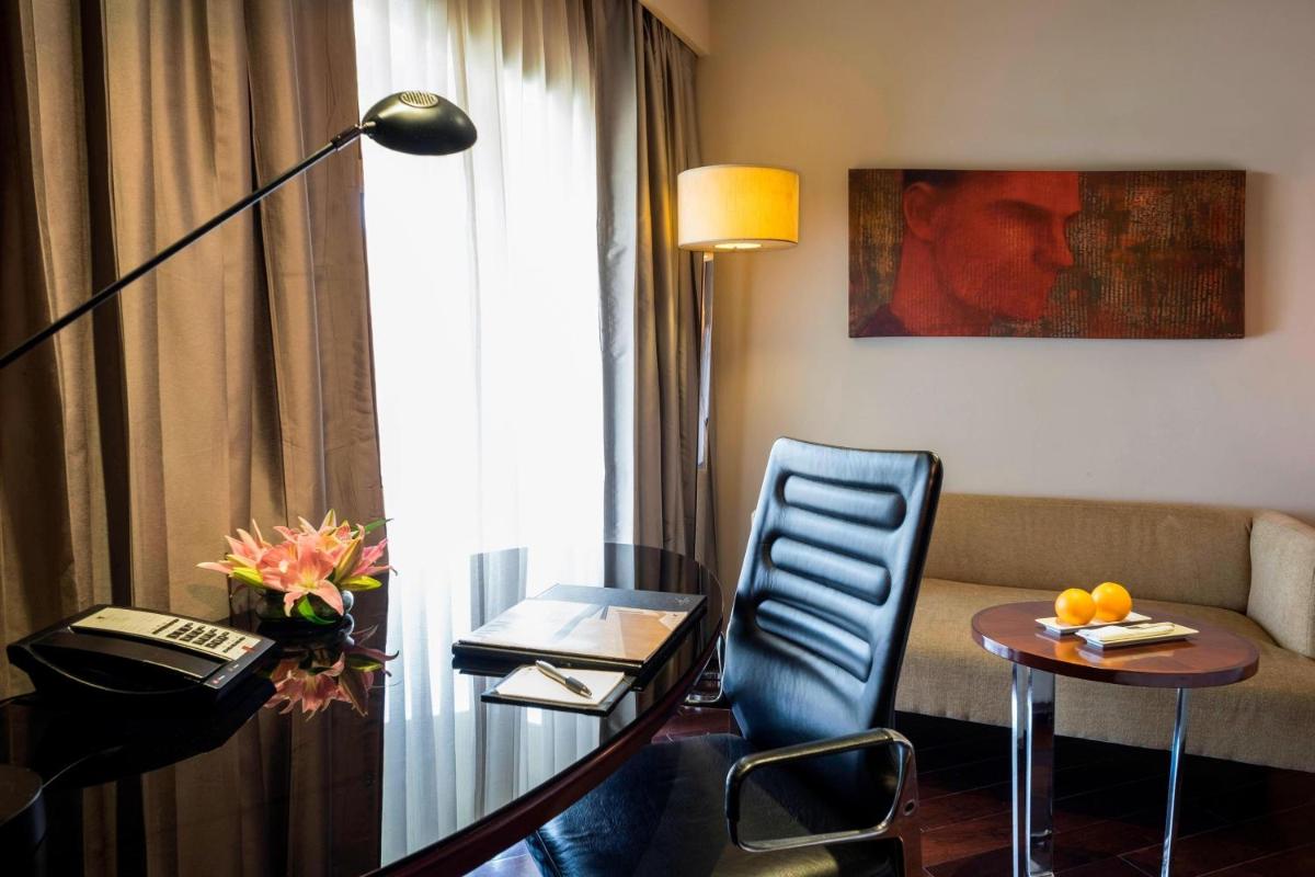a hotel room with a table and a couch at JW Marriott Mumbai Juhu in Mumbai