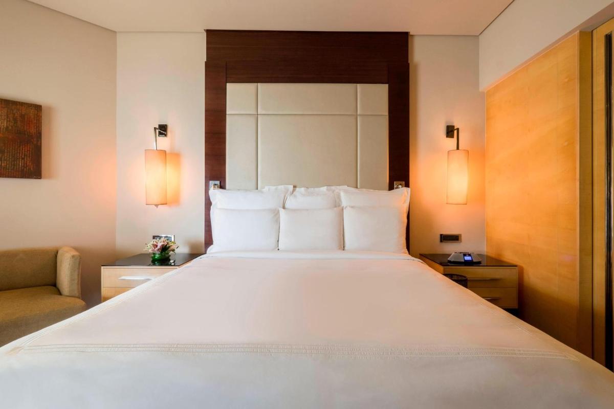 a large white bed in a hotel room at JW Marriott Mumbai Juhu in Mumbai