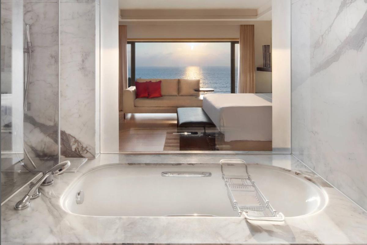 a bath tub in a living room with a couch at JW Marriott Mumbai Juhu in Mumbai