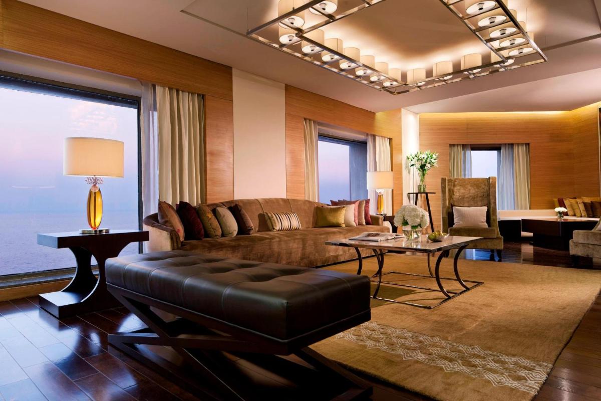 a living room with a couch and a table at JW Marriott Mumbai Juhu in Mumbai