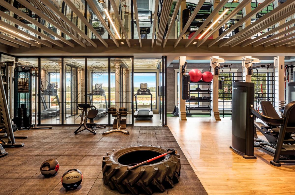 a gym with a bunch of equipment in a room at Radisson Blu Hotel & Suites GRT Chennai in Chennai