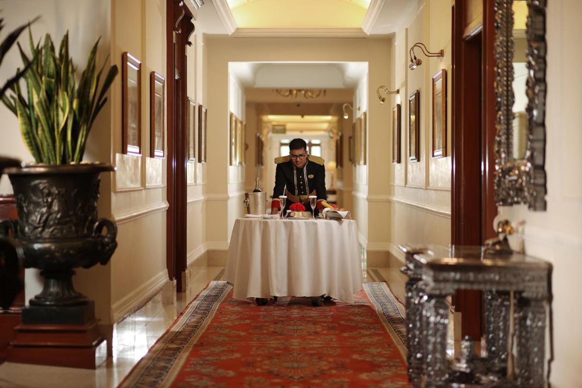 a man standing at a table in a hallway at The Imperial, New Delhi in New Delhi a man standing at a table in a hallway at The Imperial, New Delhi in New Delhi