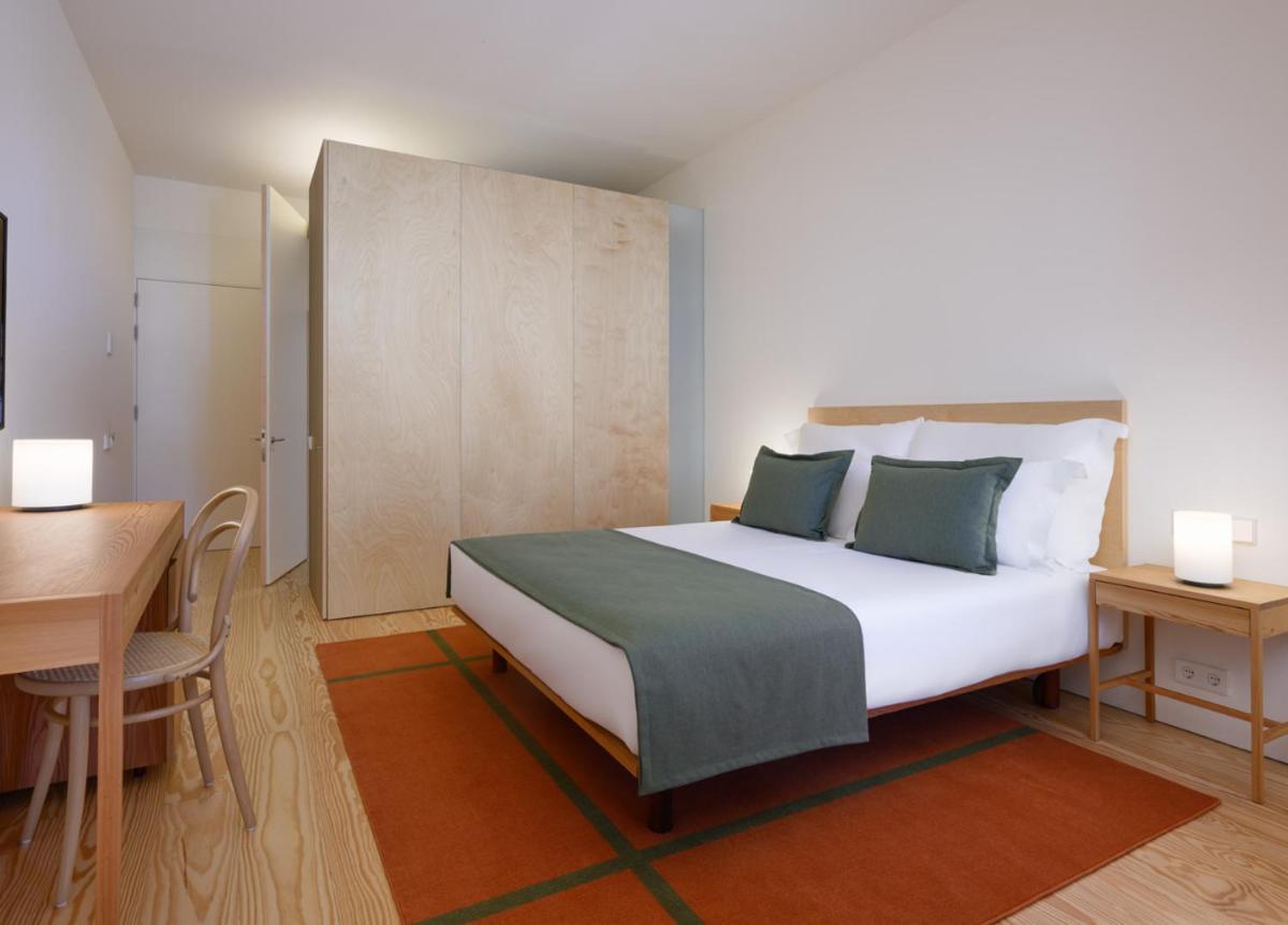Uma cama ou camas num quarto em Montebelo Mosteiro de Alcobaça Historic Hotel