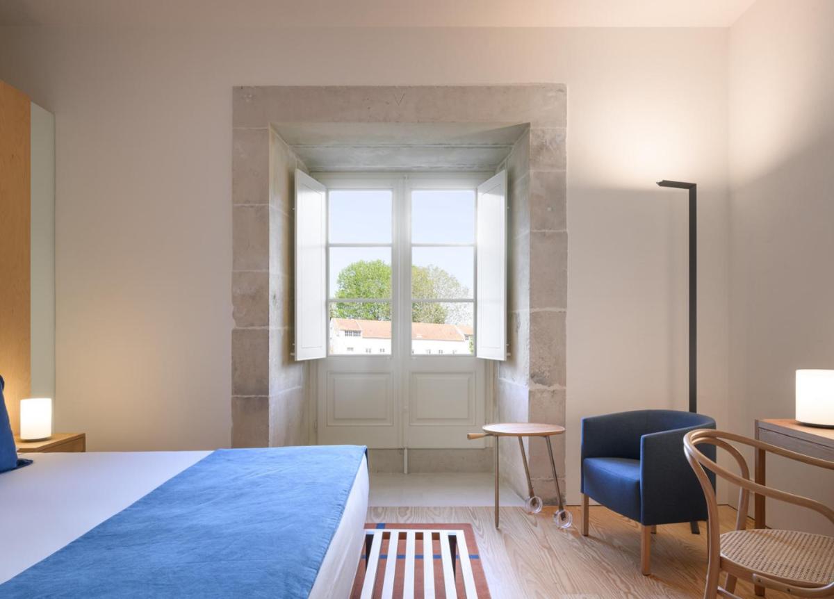 Uma cama ou camas num quarto em Montebelo Mosteiro de Alcobaça Historic Hotel