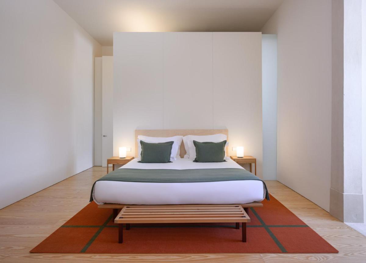 Uma cama ou camas num quarto em Montebelo Mosteiro de Alcobaça Historic Hotel