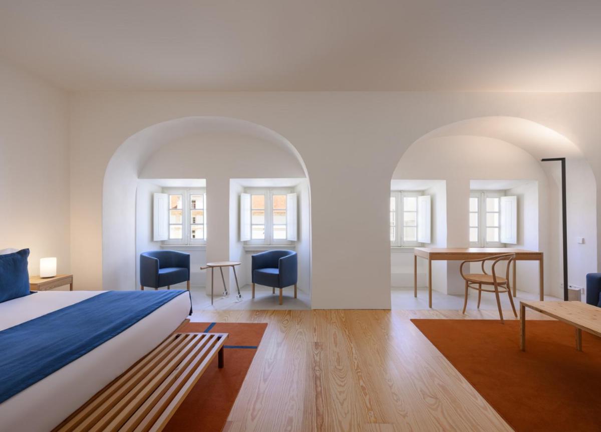 Uma cama ou camas num quarto em Montebelo Mosteiro de Alcobaça Historic Hotel