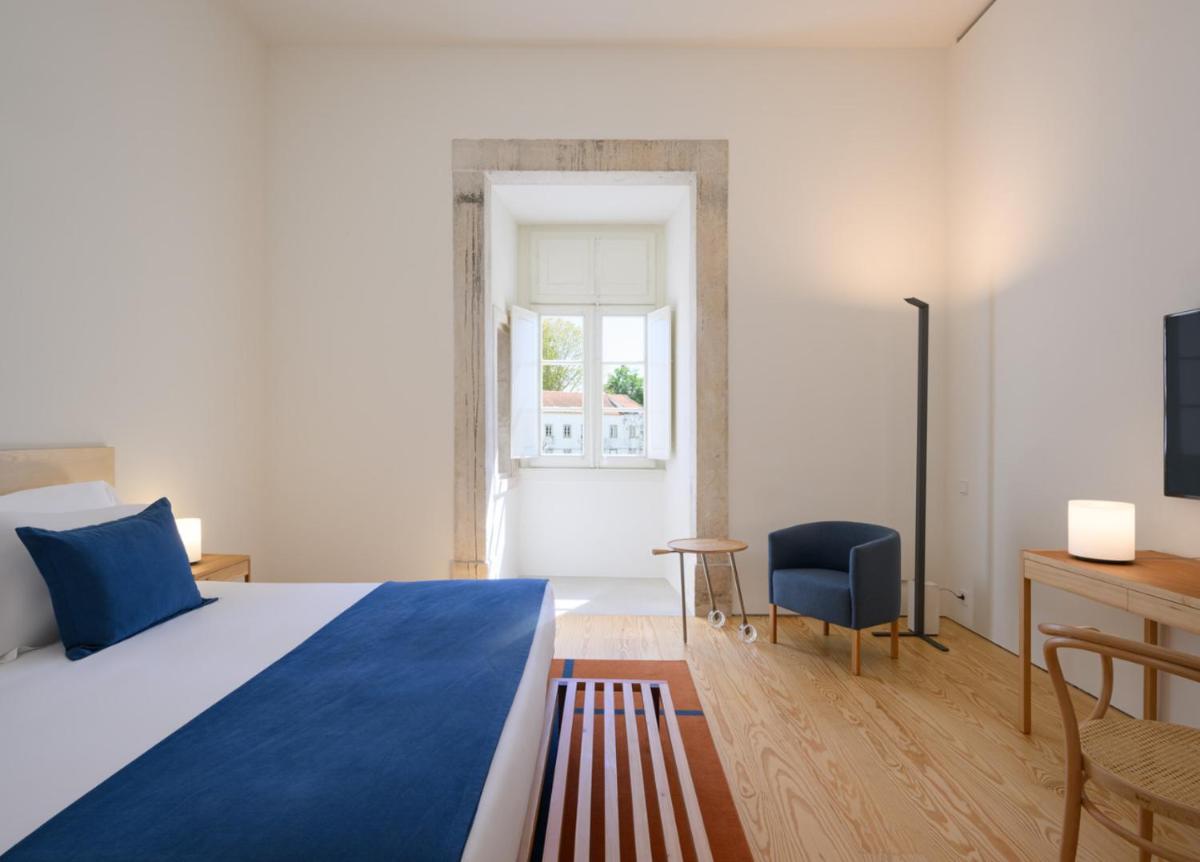 Uma cama ou camas num quarto em Montebelo Mosteiro de Alcobaça Historic Hotel