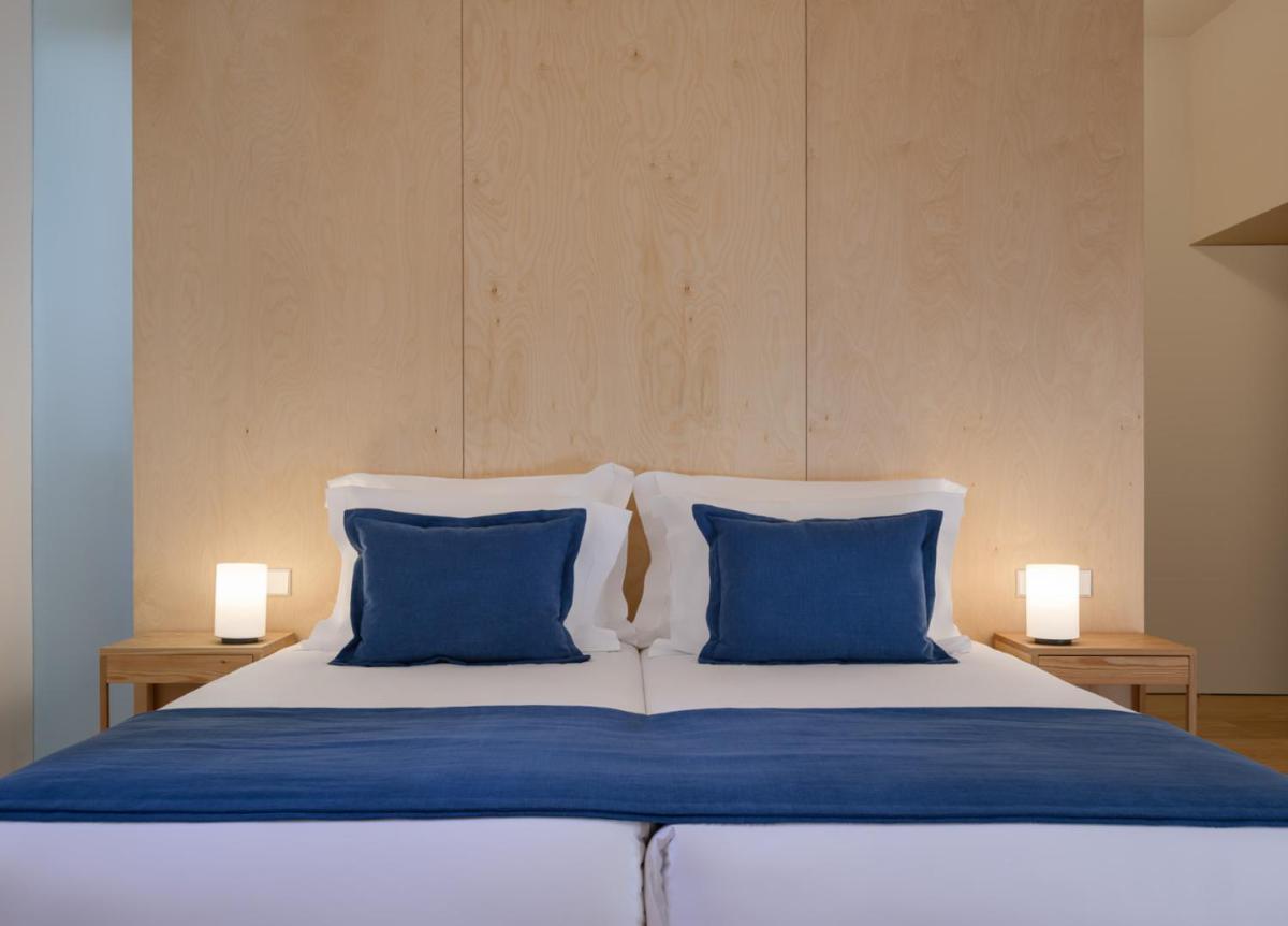 Uma cama ou camas num quarto em Montebelo Mosteiro de Alcobaça Historic Hotel