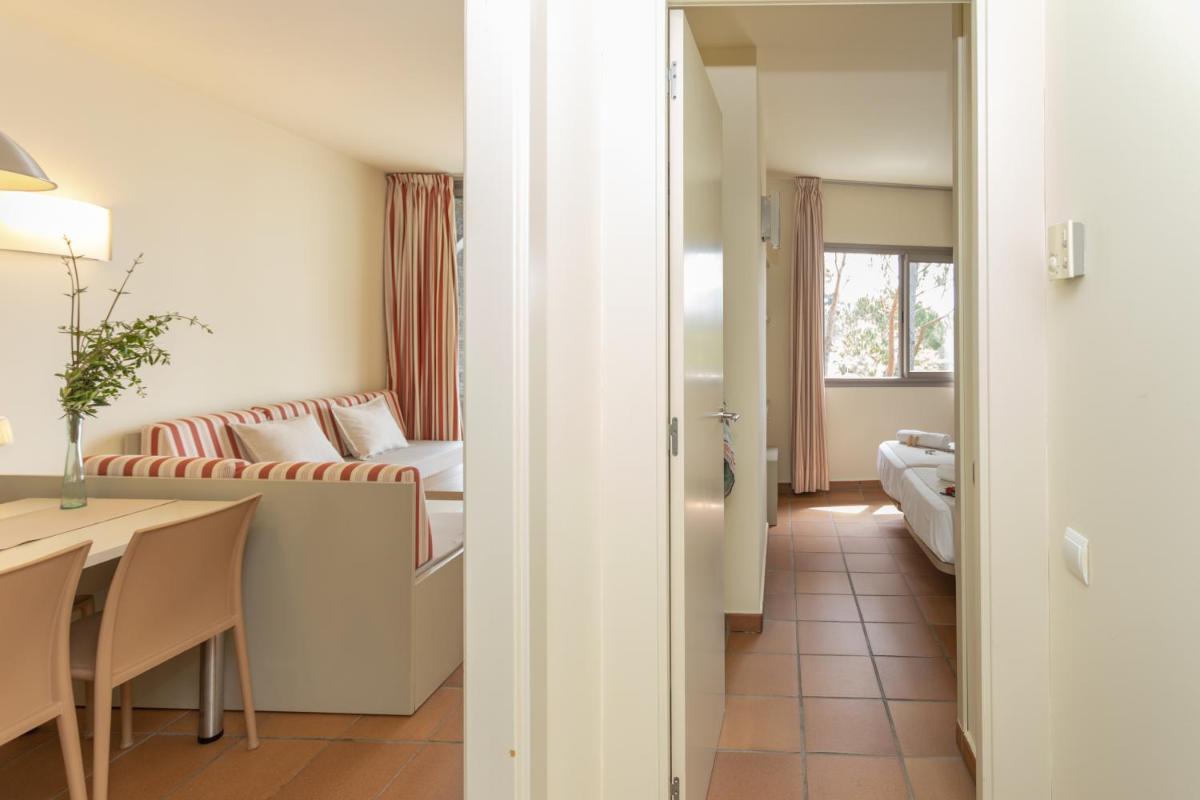 Cama o camas de una habitación en Aparthotel Ciutat de Palol