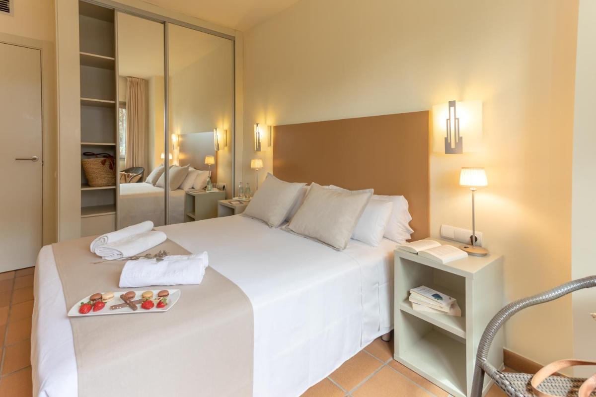 Cama o camas de una habitación en Aparthotel Ciutat de Palol