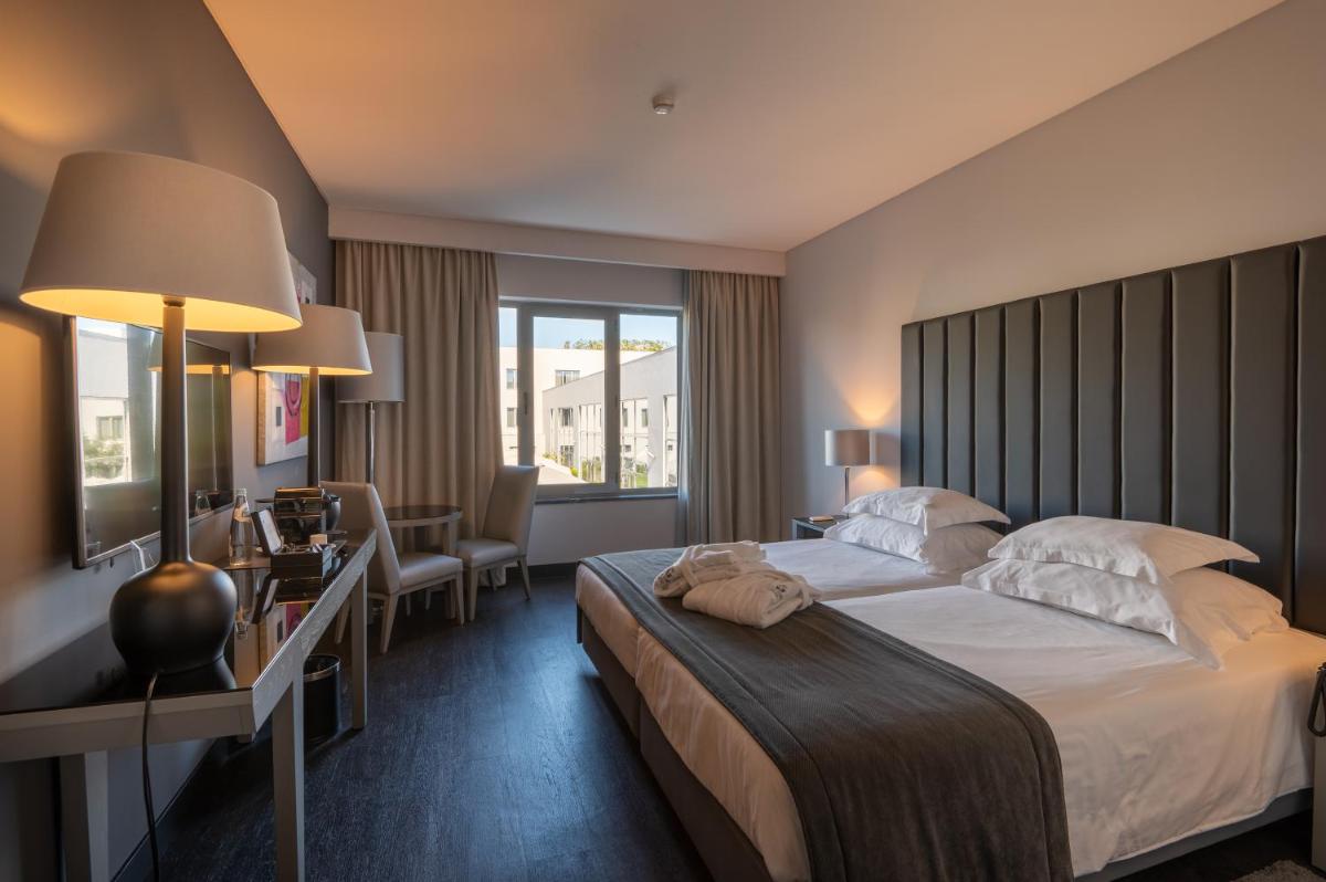 Uma cama ou camas num quarto em Vila Gale Evora