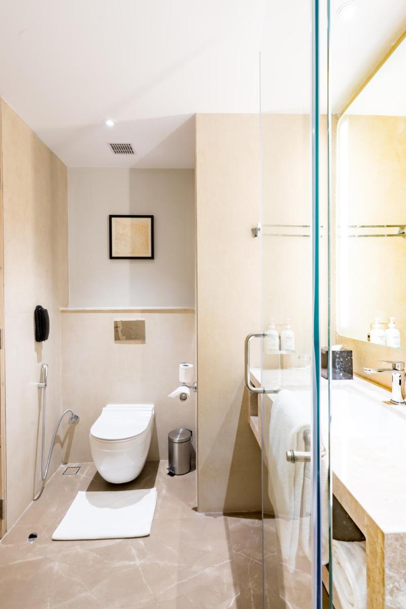 a bathroom with a toilet and a sink at Holiday Inn Lucknow Airport by IHG in Lucknow