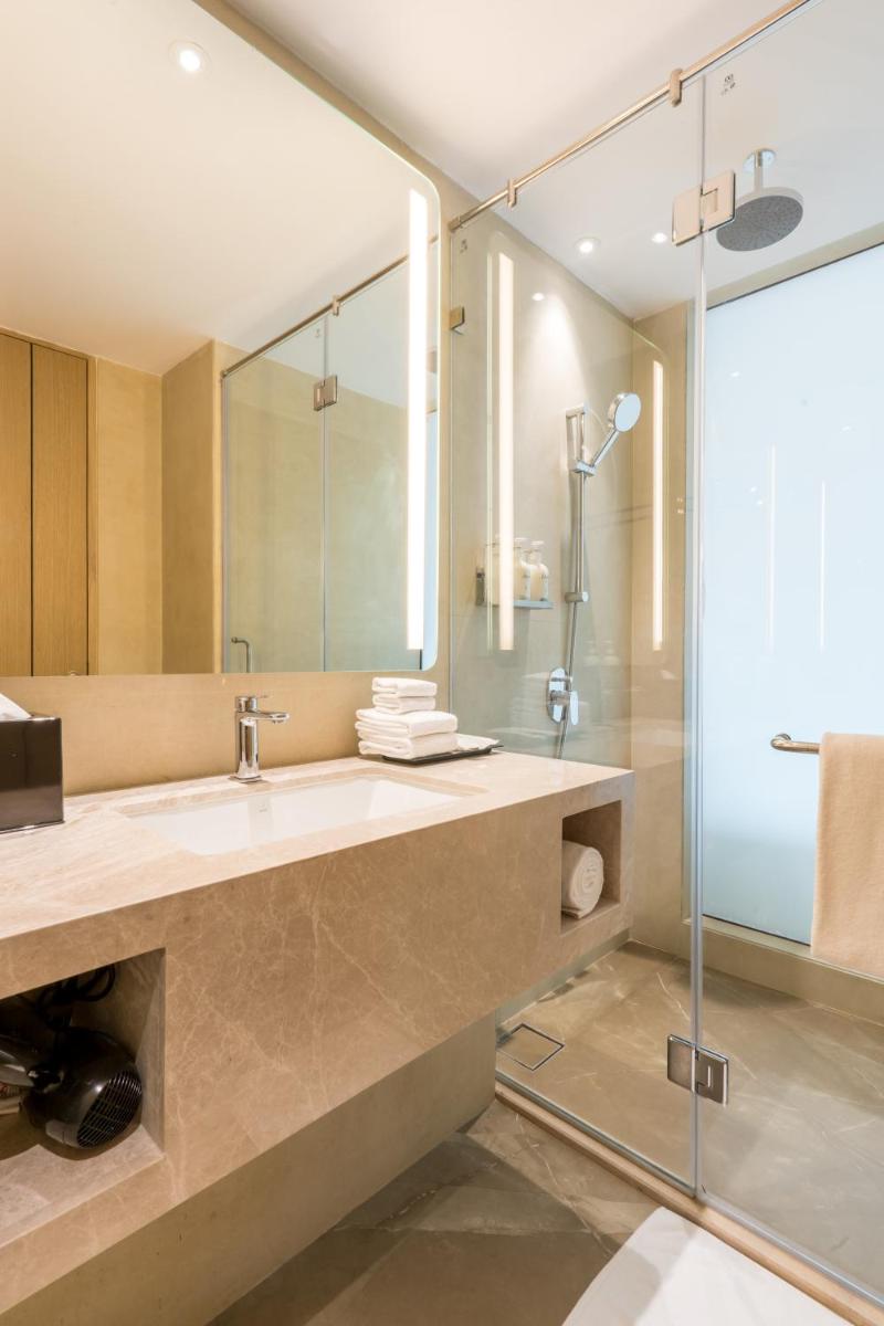 a bathroom with a sink and a shower at Holiday Inn Lucknow Airport by IHG in Lucknow