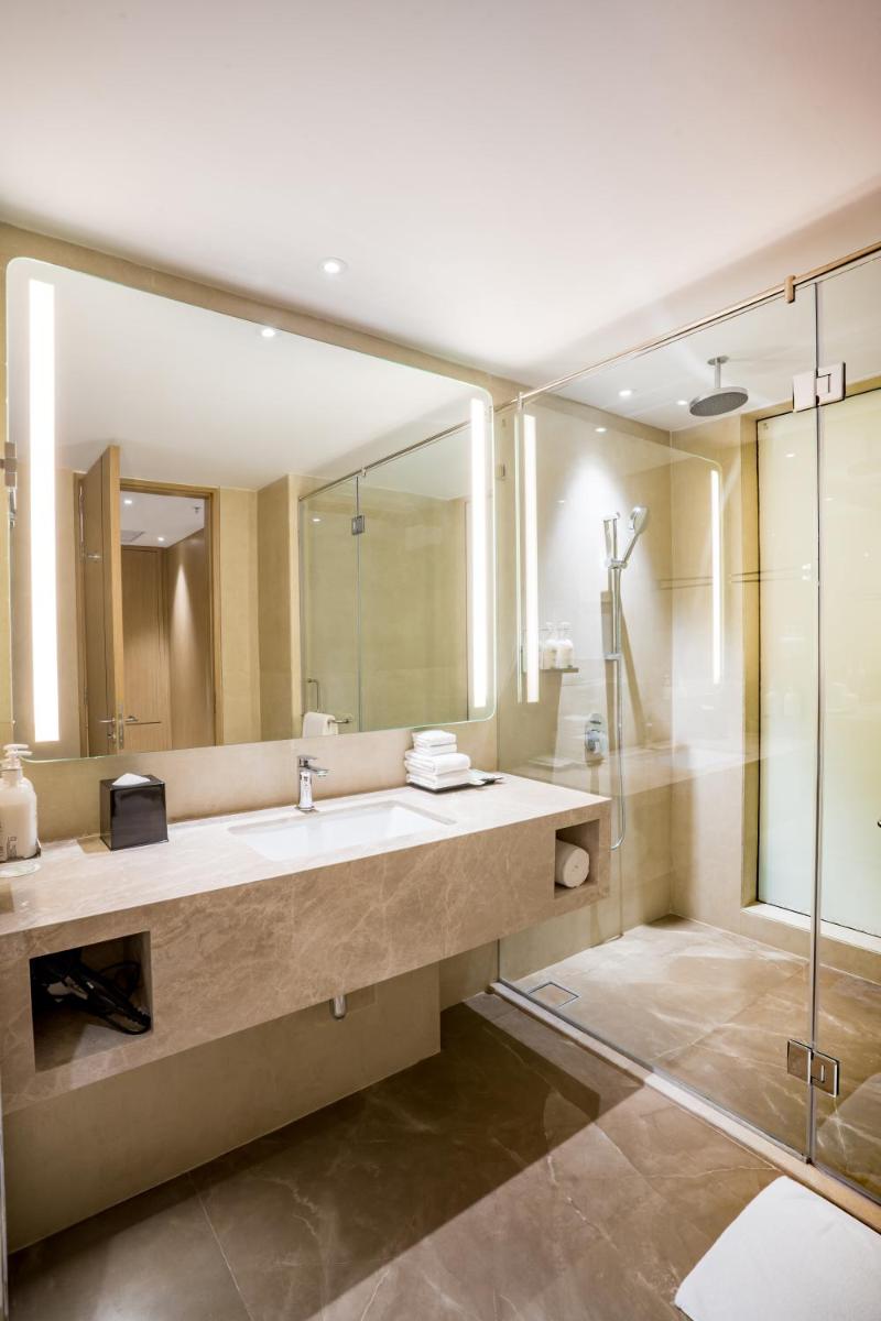 a bathroom with a sink and a shower at Holiday Inn Lucknow Airport by IHG in Lucknow