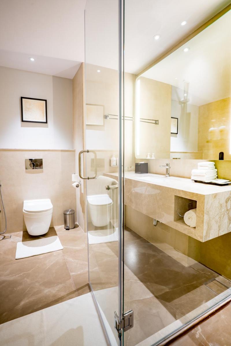 a bathroom with a toilet and a sink at Holiday Inn Lucknow Airport by IHG in Lucknow