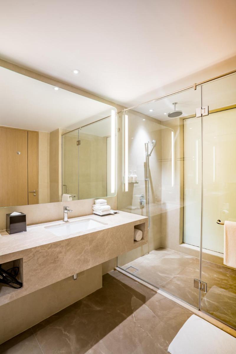 a bathroom with a large sink and a shower at Holiday Inn Lucknow Airport by IHG in Lucknow