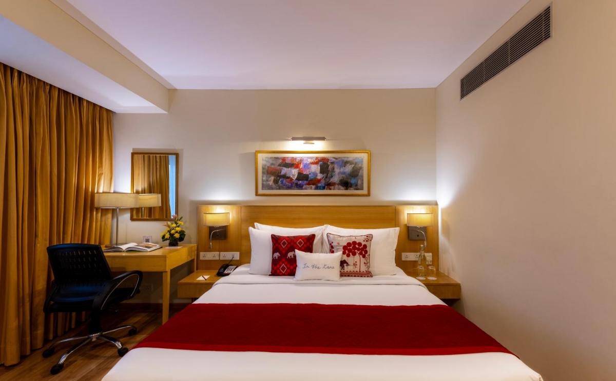 a hotel room with a large bed and a desk at Zone Connect by The Park Saket New Delhi in New Delhi a hotel room with a large bed and a desk at Zone Connect by The Park Saket New Delhi in New Delhi