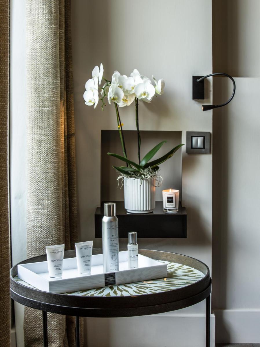 - une table ronde avec un vase de fleurs dans l'établissement Les Lodges Sainte-Victoire Hotel & Spa, à Aix-en-Provence