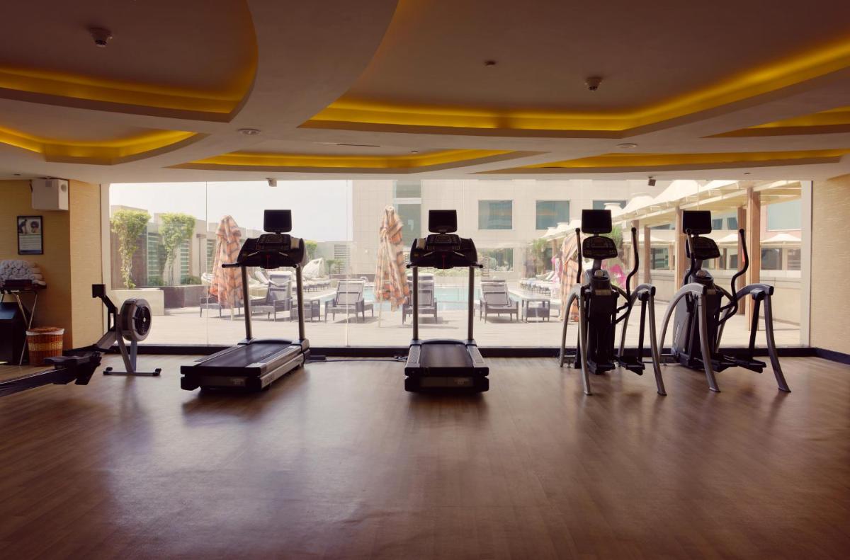 a gym with several camera equipment in a room at Radisson Blu Kaushambi Delhi NCR in Ghaziabad