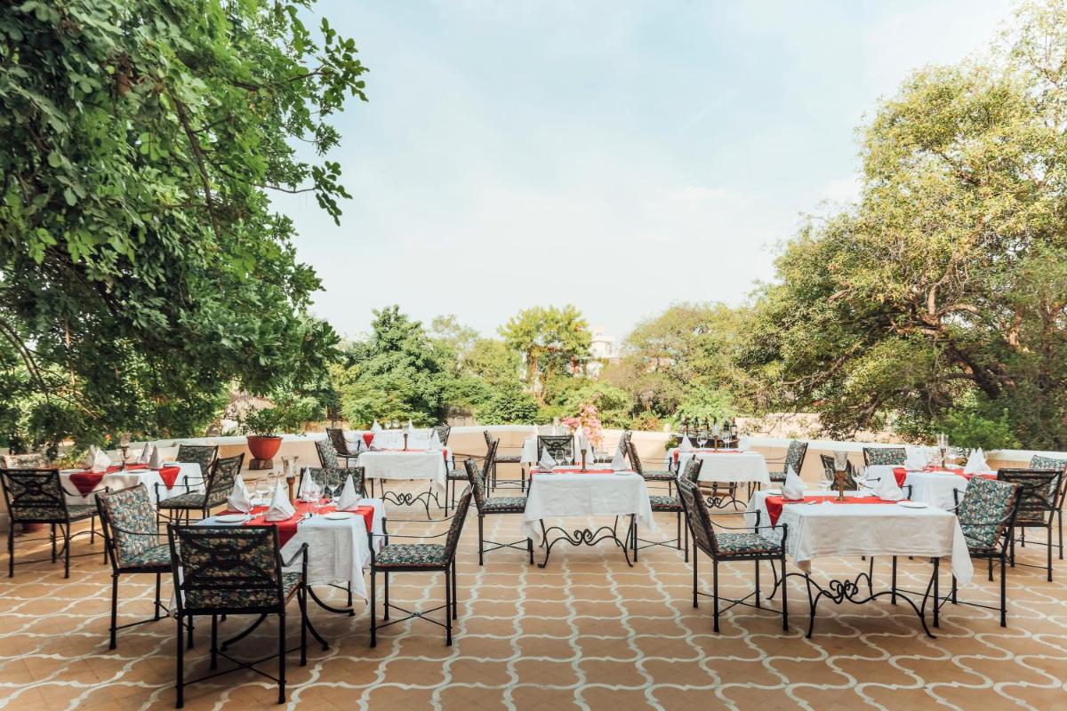 a group of tables and chairs on a patio at Royal Heritage Haveli - By Leisure Hotels in Jaipur