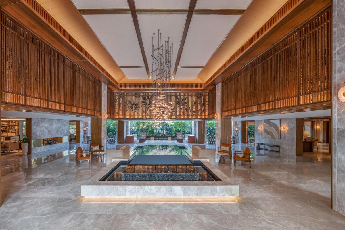 a lobby with a fountain in the middle of a room at JW Marriott Goa in Vagator a lobby with a fountain in the middle of a room at JW Marriott Goa in Vagator