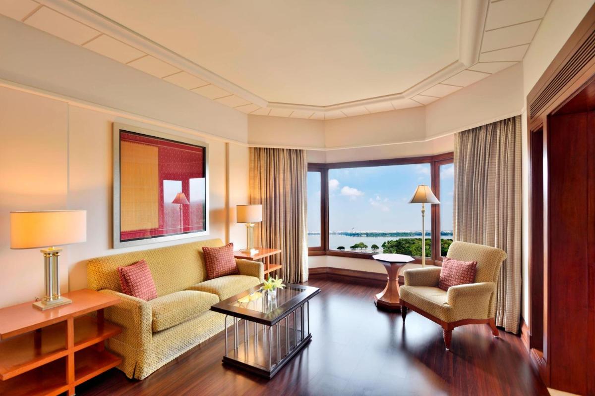 a living room with a couch and two chairs at Hyderabad Marriott Hotel & Convention Centre in Hyderabad