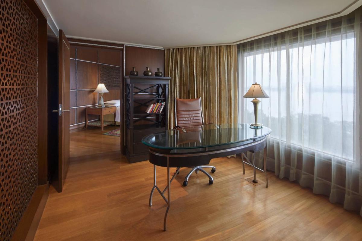 a room with a glass table and a window at Hyderabad Marriott Hotel & Convention Centre in Hyderabad