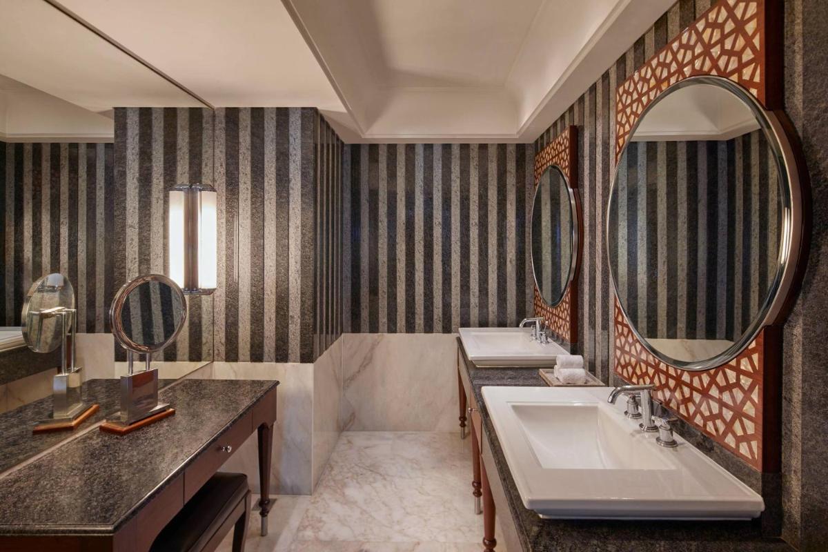 a bathroom with two sinks and a large mirror at Hyderabad Marriott Hotel & Convention Centre in Hyderabad