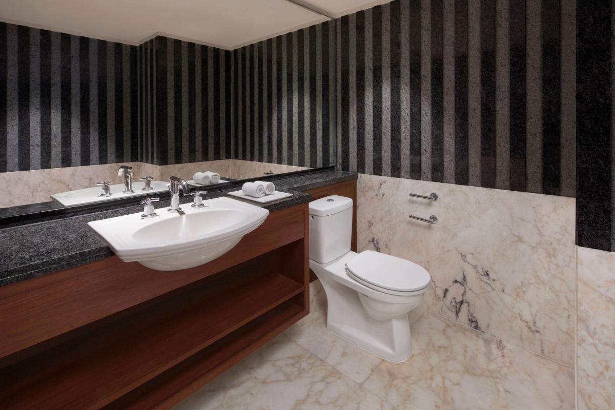 a bathroom with a toilet and a sink at Hyderabad Marriott Hotel & Convention Centre in Hyderabad