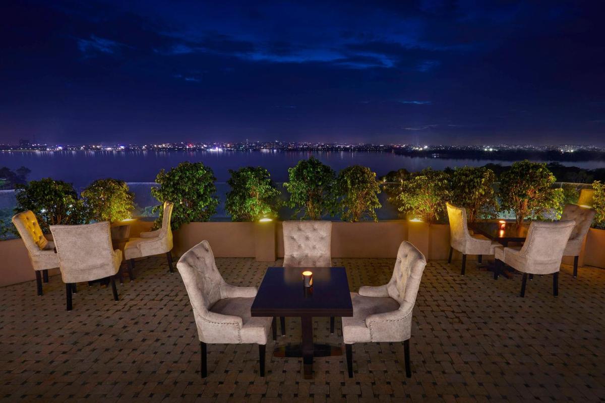 a patio with chairs and a table with a candle at Hyderabad Marriott Hotel & Convention Centre in Hyderabad