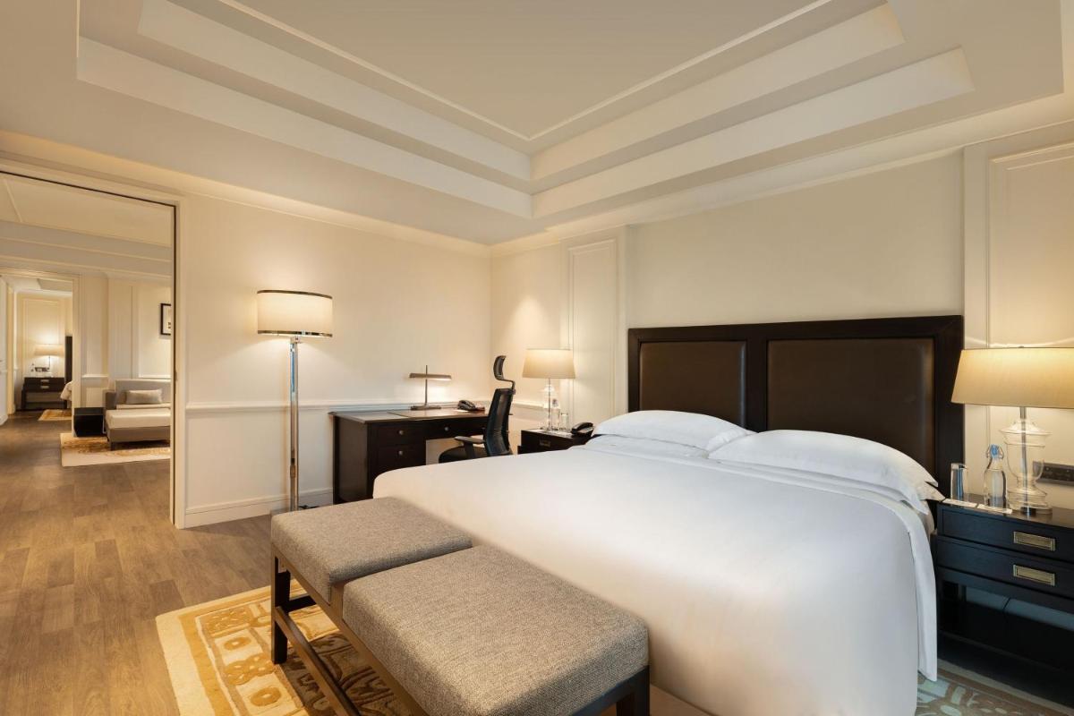 a bedroom with a large white bed and a desk at ITC Royal Bengal, a Luxury Collection Hotel, Kolkata in Kolkata