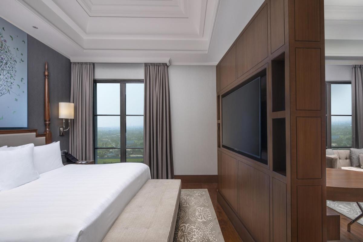 a bedroom with a bed and a flat screen tv at ITC Royal Bengal, a Luxury Collection Hotel, Kolkata in Kolkata