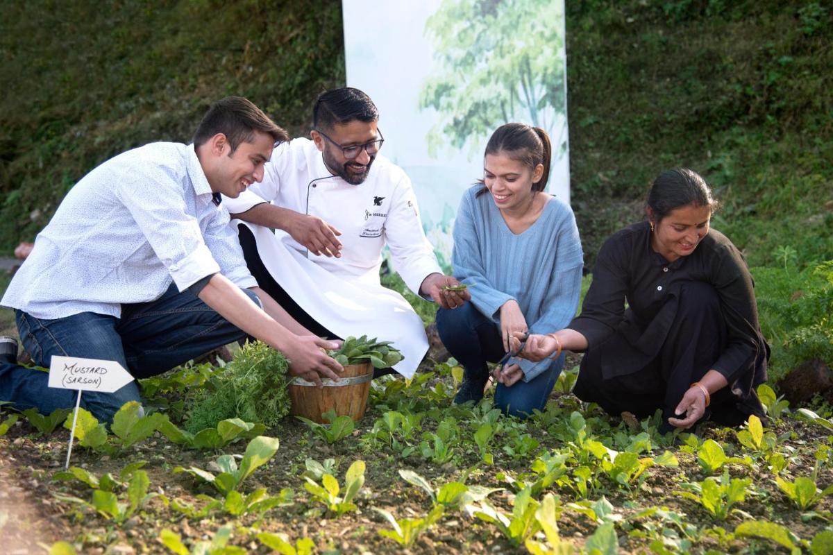 a group of people working in a garden at JW Marriott Mussoorie Walnut Grove Resort & Spa in Mussoorie