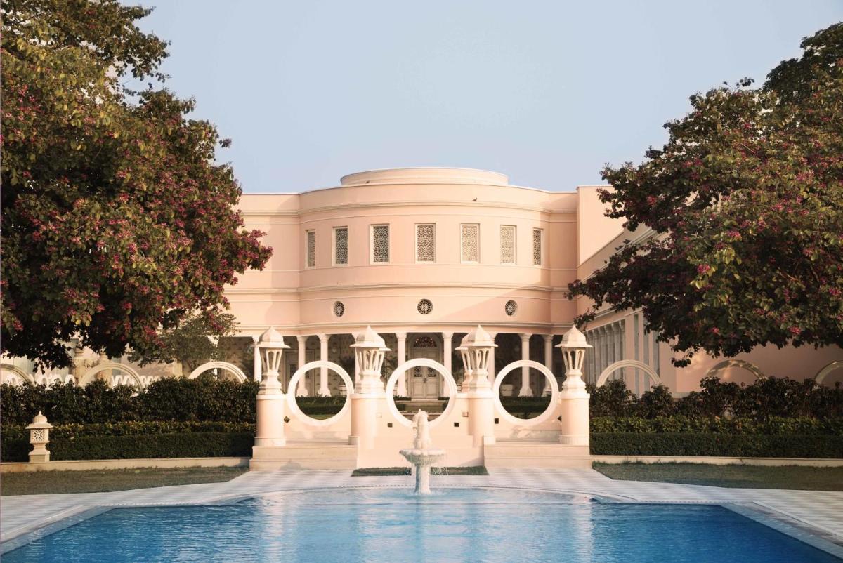 a white building with a fountain in front of it at Rajmahal Palace RAAS in Jaipur