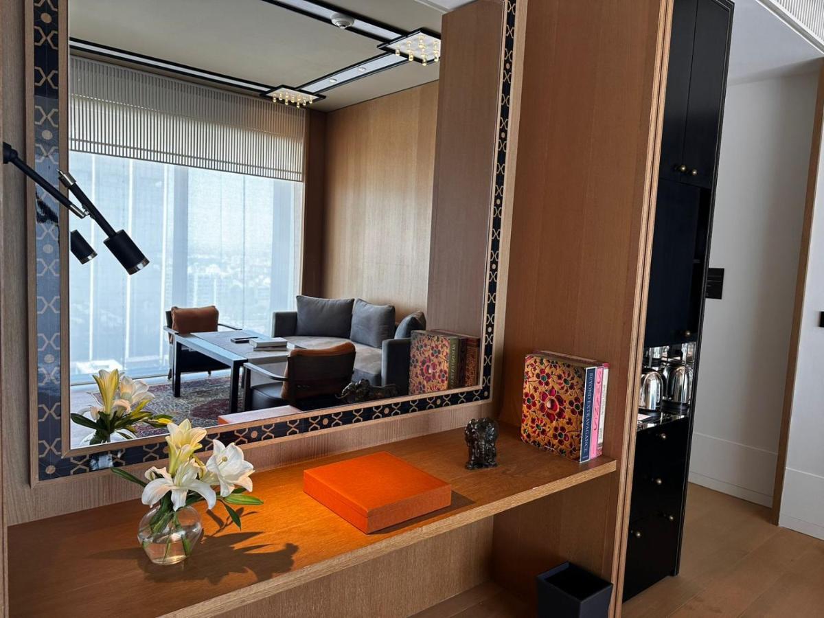 a living room with a mirror and a couch at Grand Hyatt Gurgaon in Gurgaon