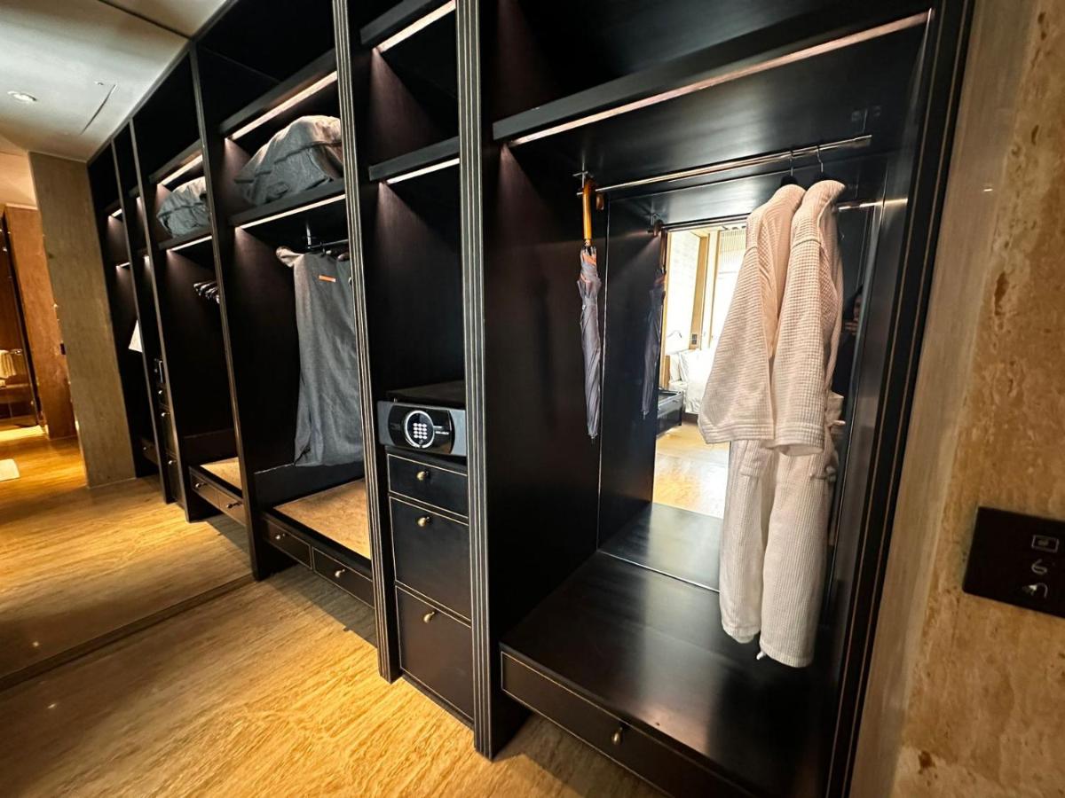 a closet with black cabinets and white towels at Grand Hyatt Gurgaon in Gurgaon