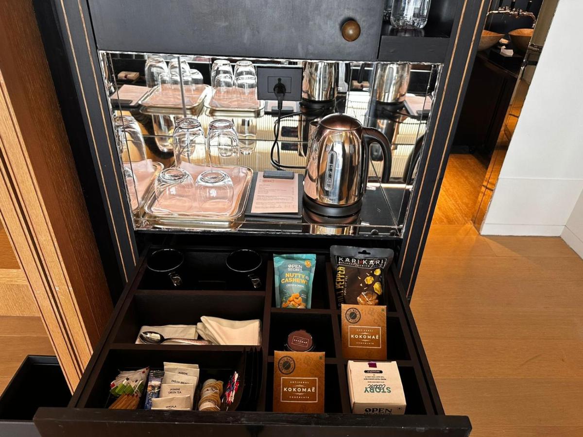 a refrigerator filled with food and a tea kettle at Grand Hyatt Gurgaon in Gurgaon