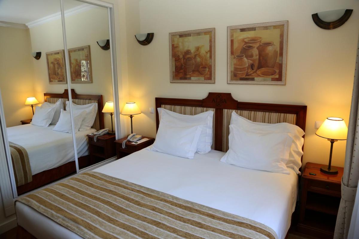 Uma cama ou camas num quarto em Vila Alba Resort
