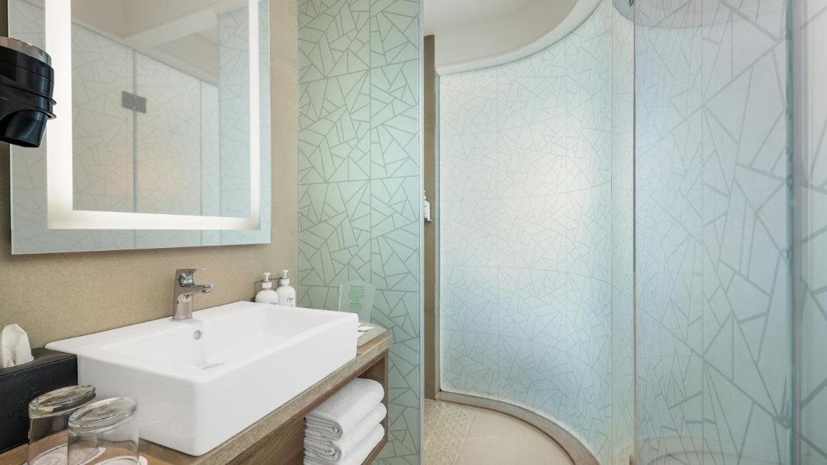 a bathroom with a sink and a shower at Holiday Inn Gurugram Sector 90 by IHG in Gurgaon