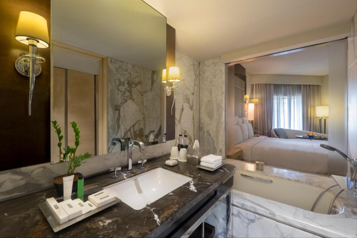 a bathroom with a sink and a large mirror at JW Marriott Mumbai Juhu in Mumbai