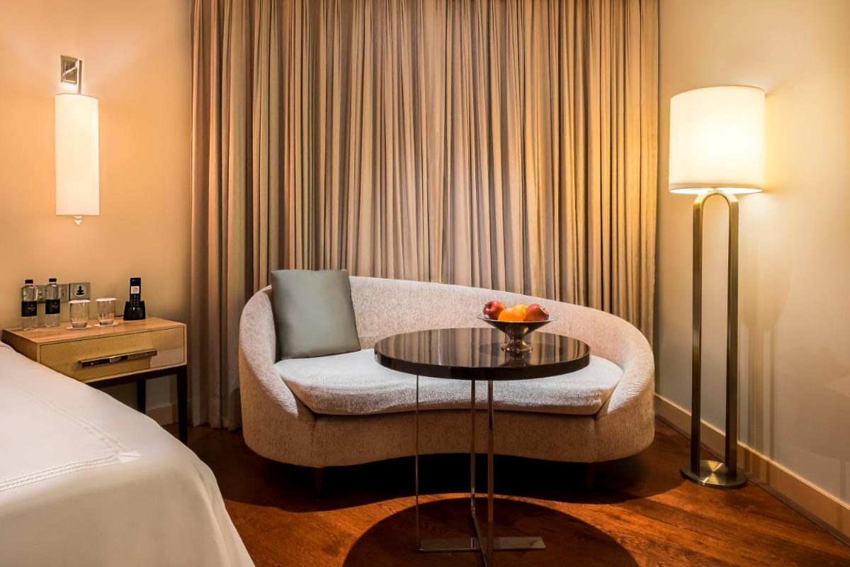 a hotel room with a couch and a table at JW Marriott Mumbai Juhu in Mumbai