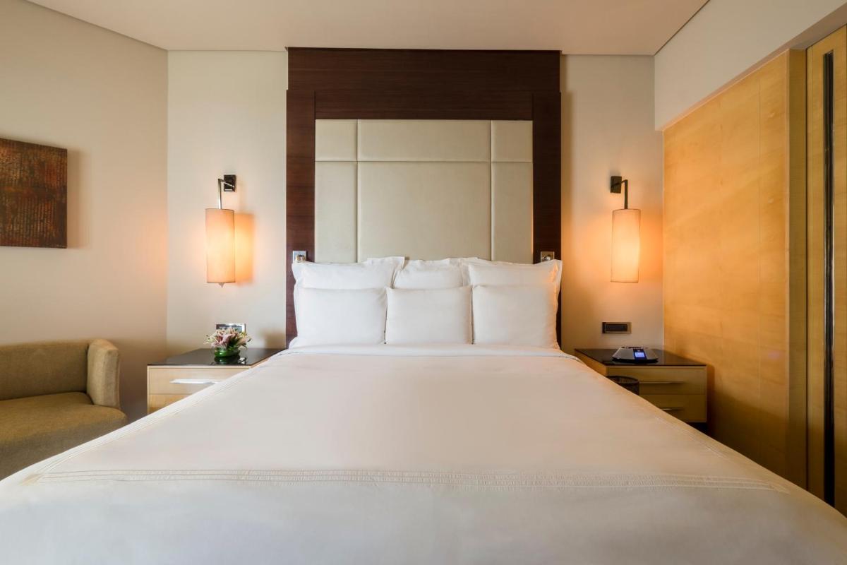 a large white bed in a hotel room at JW Marriott Mumbai Juhu in Mumbai