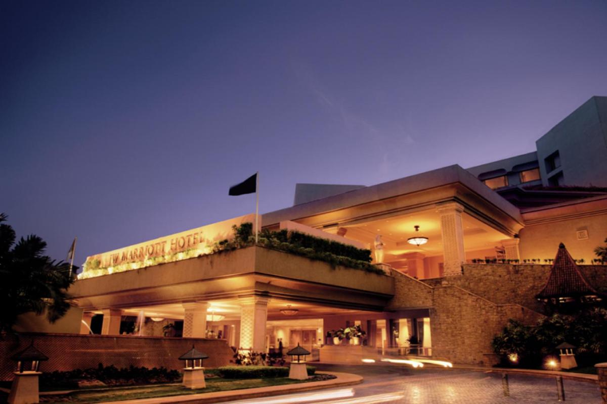 a building with a flag in front of it at night at JW Marriott Mumbai Juhu in Mumbai