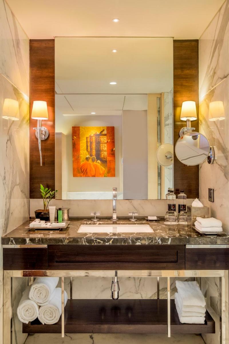 a bathroom with a sink and a large mirror at JW Marriott Mumbai Juhu in Mumbai